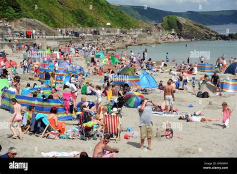 Looe beach, Cornwall, UK. Tourists enjoy the weather at Looe beach in ...