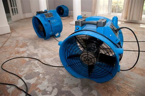 industrial fans used to dry floor of water damaged home