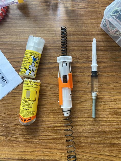 disassembled used EpiPen revealing how it works, as well as the extra ...