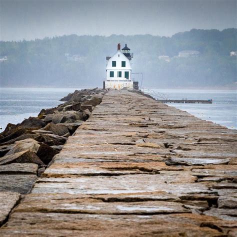 a white house sitting on top of a wooden pier