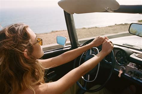 Woman driving convertible • The Americana at Brand