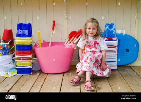 happy little girl choosing beach toys Stock Photo - Alamy