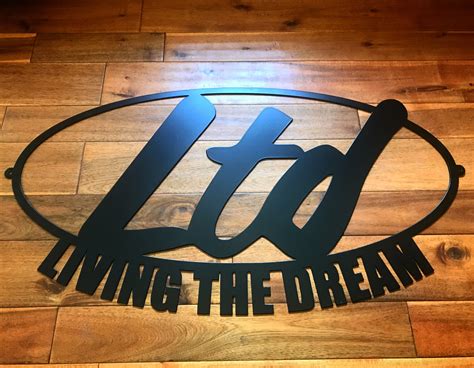 the logo for living the dream is shown on a wooden floor in front of a ...