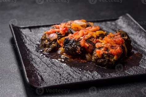 Dolma, stuffed grape leaves with rice and meat on a dark background ...