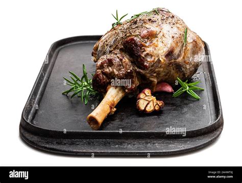 Whole roast lamb leg on grill tray isolated on white Stock Photo - Alamy