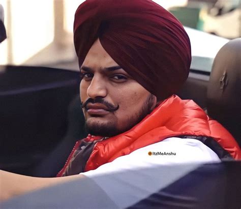 a man in a turban is sitting in a car