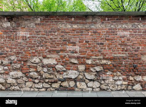 Background old brick wall with small and big stones Stock Photo - Alamy