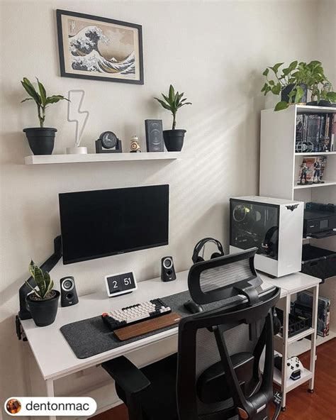 a computer desk topped with a monitor and keyboard