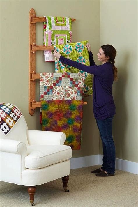 A hanging quilt rack that holds four quilts! Great space saver! Woo