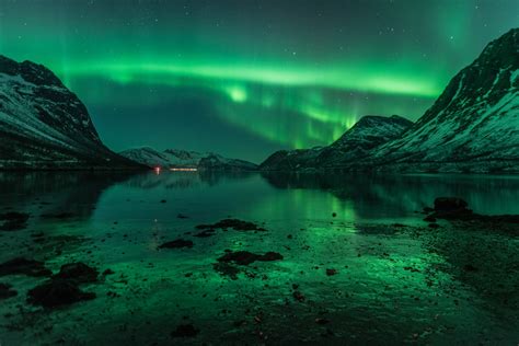 North Norway, Aurora Borealis reflecting on water and ice © Johan ...