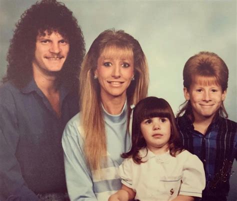 the family is posing for a photo in front of a blue background with ...