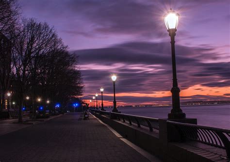 Photography of Turned on Street Lamps Beside Bay during Night Time ...