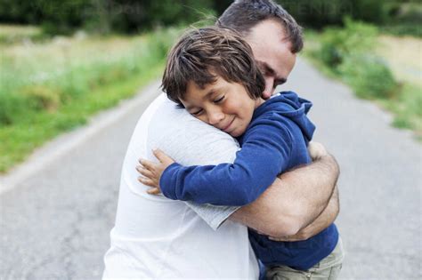 Happy father and little son hugging each other stock photo