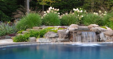 A beautiful swimming pool waterfall comes from the upper level spa ...