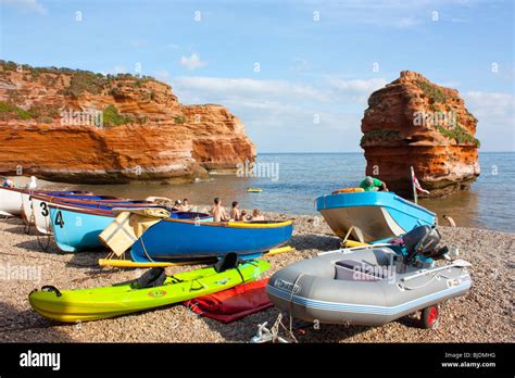 Boats and Kayaks on the beach at Ladram Bay, Devon England UK Stock ...