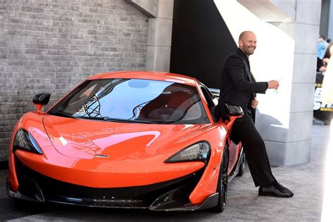 Jason Statham oozes obvious cool as he poses with the slick supercars ...