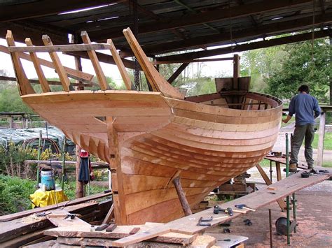 Caulking the oak planking on an English cutter. It appears to be partly ...