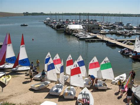 several sailboats are parked on the beach near boats in the water and ...