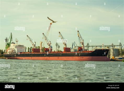 cargo ship with port cranes Stock Photo - Alamy