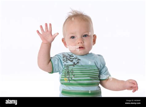 Baby boy waving goodbye Stock Photo - Alamy