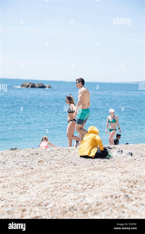 Dorset, England, UK - June 2019: Hot weather day at sea side on pebble ...