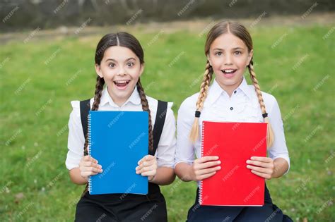 Premium Photo | Happy kids in school uniforms show colorful schoolbooks ...