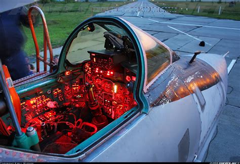 the cockpit of an airplane with red lights on it's windows and dashboards