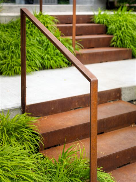 some brown steps with green plants and grass on the bottom one is metal ...