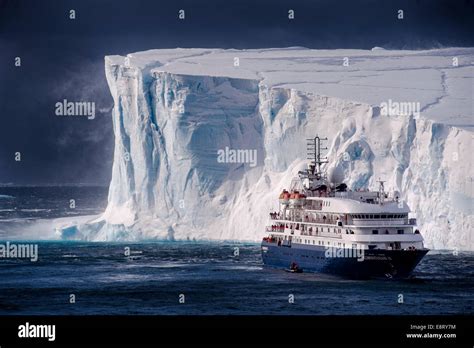 A dramatic encounter between a cruise ship and large tabular iceberg in ...