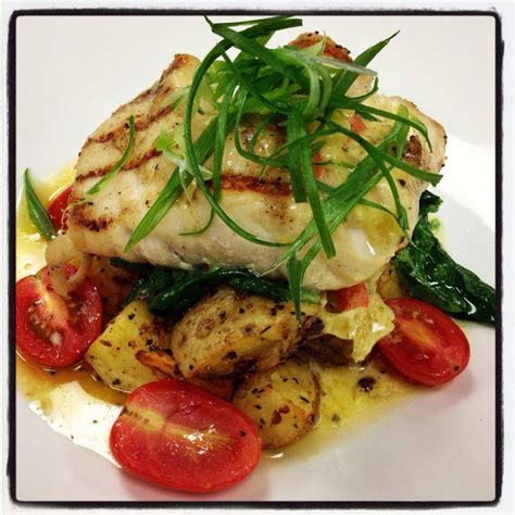 Grilled corvina with herb and garlic roasted Yukon potatoes, spinach ...