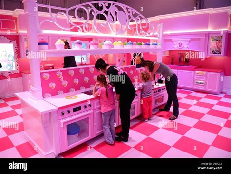 The pink kitchen is pictured in the Barbie Dreamhouse Experience near ...