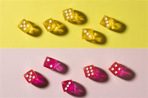 Yellow and pink dice on colorful background 2410759 Stock Photo at Vecteezy