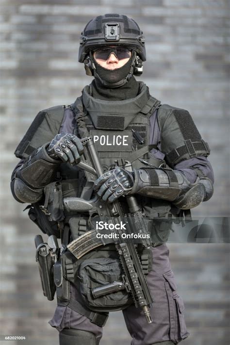 Swat Police Officer Against Brick Wall Stock Photo - Download Image Now ...