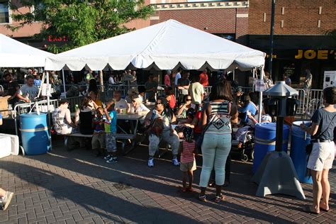 Picnic tables under a frame tent at the 2014 Iowa Arts Festival. - Iowa ...