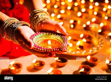 Traditional Indian woman lighting Diya Diwali Festival Stock Photo - Alamy