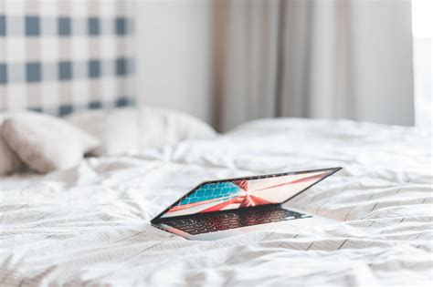 Laptop Lying in a Bed Free Stock Photo | picjumbo