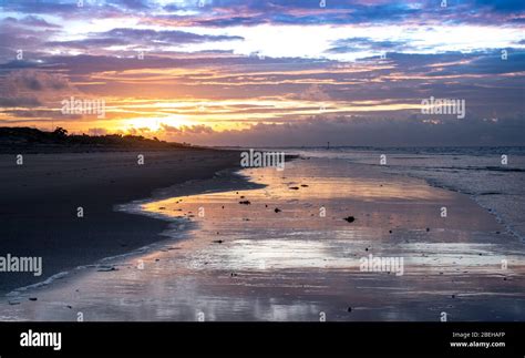 West Wittering beach at sunset with the sun low on the horizon, West ...