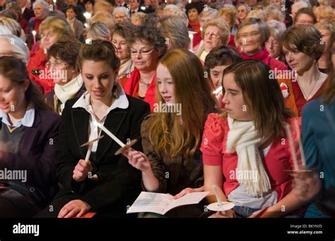 Congregation singing and holding candles during filming of BBC Songs of ...