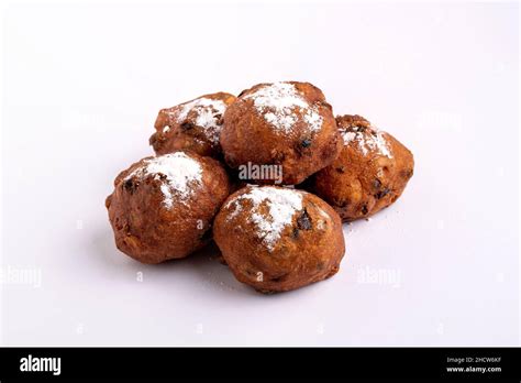 A pile of Dutch traditional oliebollen with powdered sugar isolated on ...