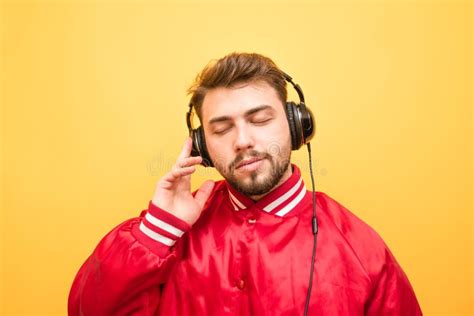 Close-up Portrait of an Adult Man Listens To Music in Headphones with ...