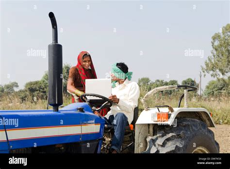 Indian farmer driving tractor Stock Photo - Alamy