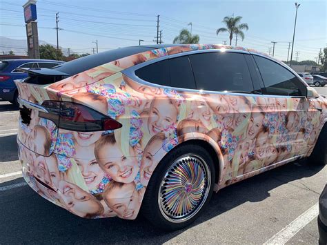 OP buys a Tesla. Slaps a bunch of Jojo Siwa stickers on it and leaves ...