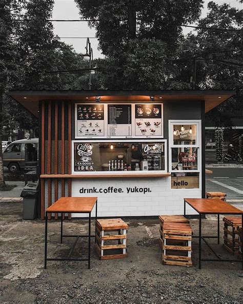 an outdoor coffee shop with tables and stools around the outside table ...