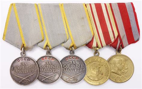 Group of Soviet medals consisting of 3 medals for Combat Merit, Medal ...