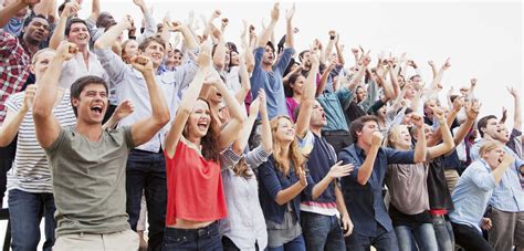 Cheering fans in crowd stock photo