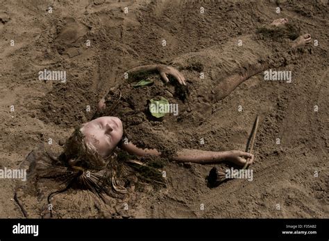 Girl buried in sand hi-res stock photography and images - Alamy