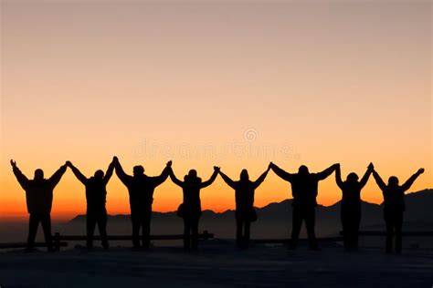 Friendship. Group of friends holding hands during the last sunset of ...