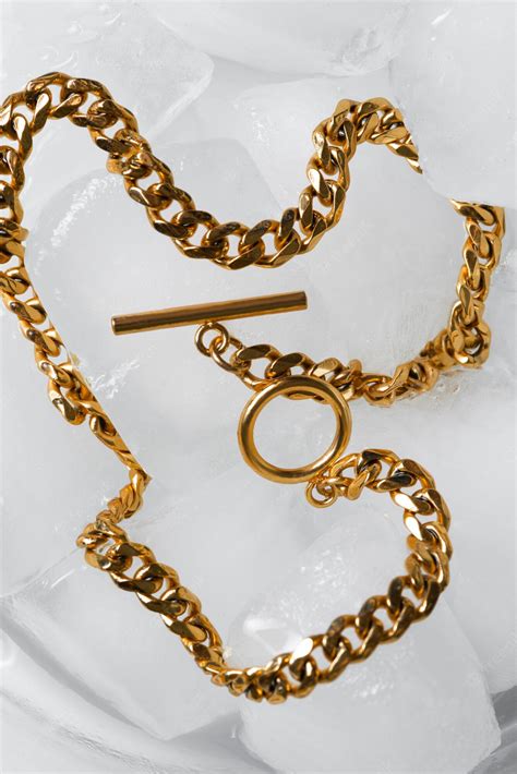 Premium Photo | Flat lay gold chain on ice cubes