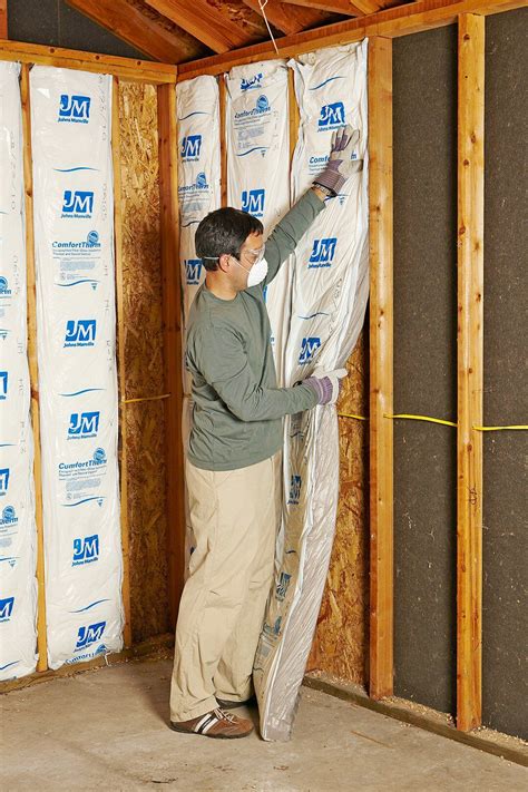 installing insulation batting to walls Insulating Garage Walls ...