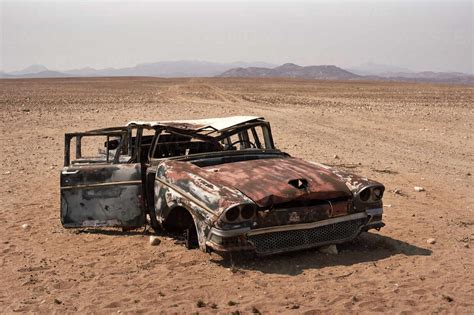 Abandoned car at the Namibe Desert, Namibe, Angola stock photo